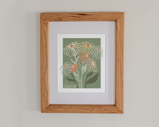 An art print line drawing of daisies in bloom in a cherry hardwood frame